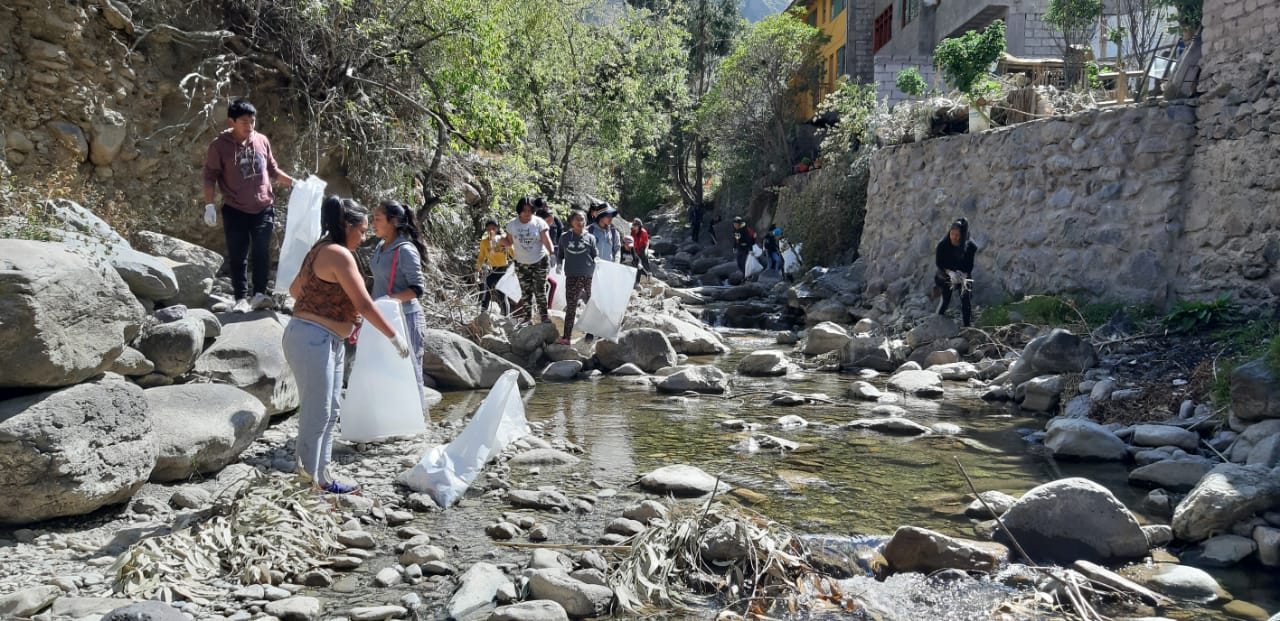 young adults cleaning up river