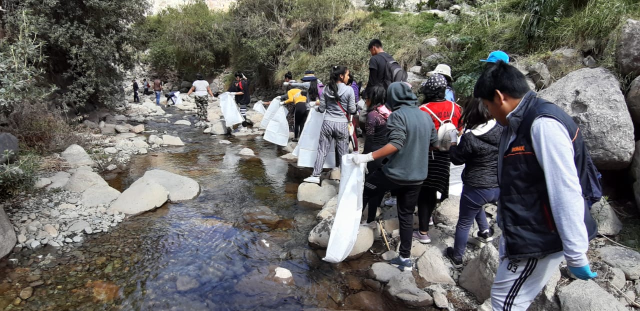 young adults cleaning up river